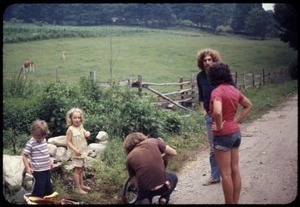 Eben Light and Sequoya Frey, Benny, Gary, and Nina Keller talking while repairing a bicycle, Montague Farm Commune
