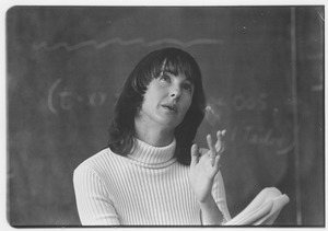 Dr. Alice H. Eagly indoors, in front of chalkboard, speaking