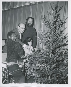 Dr. DiMichael and unidentified man decorating Christmas tree with clients