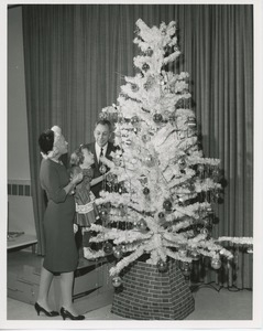 Margaret Milbank Bogert, Mr. Burrows, and young patient decorating Christmas tree