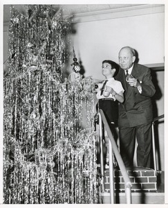 Jeremiah Milbank, Sr. decorating Christmas tree with young client