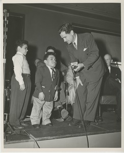 Unidentified special guest speaking with client on stage at Institute Day