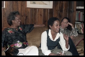 Johnnetta Cole, Esther Terry, and unidentified woman (r. to l.) seated on a couch,at the book party for Robert H. Abel
