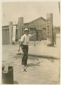 Tasuke Yuasa standing next to a gate