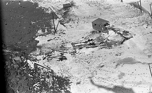 Aerial view of damaged structure on snowy beach