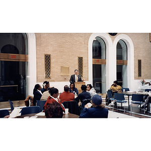 A man speaks from the lectern at a town hall meeting