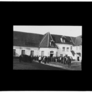 Gathering in front of white building