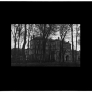 Large brick building through trees