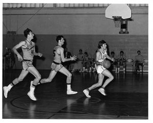 Suffolk University men's basketball team game, Allan Dalton heads for the basket, 1969-1970
