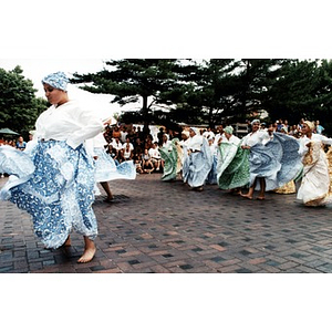 Young women performing a traditional dance in the plaza before a crowd of Festival Betances spectators.
