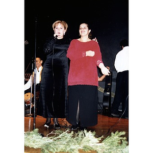 Two women on stage at the Jorge Hernandez Cultural Center during an evening of musical performances.