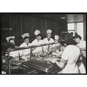 Members of the Tom Pappas Chefs' Club wait on line in a Brandeis University dining hall