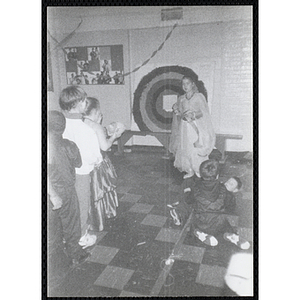 Children in costumes stand on line for a game at a Halloween event