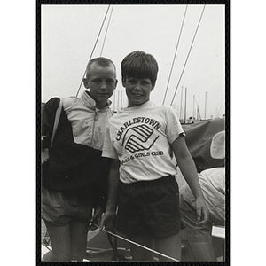 Two boys standing on a dock