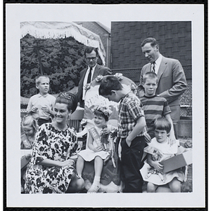 Miss South Boston, the winner of the Boys' Club Little Sister Contest, posing with a female judge while her brother and other judges look on