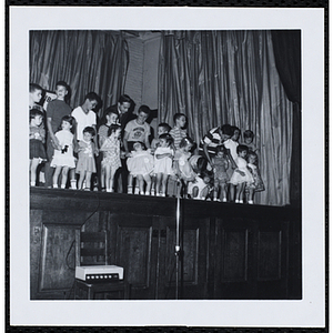 Contestants standing on the stage with their brothers during a Boys' Club Little Sister Contest