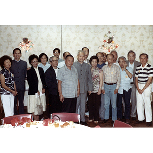 Men and women stand in a banquet room