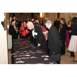 Guests look at photographs at the inauguration celebration of President Aoun
