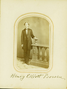 Full-length studio portrait of Henry Elliott Bowen, standing, facing front, holding on to a balustrade, location unknown