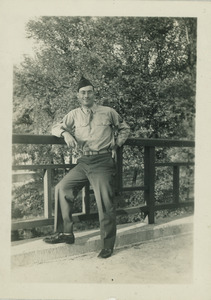 Sidney Lipshires in military uniform, posing by a bridge