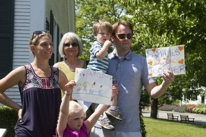 Family protesting outside the Chatham town office building, holding a sign reading 'Families belong together': taken at the 'Families Belong Together' protest against the Trump administration’s immigration policies