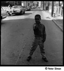 African American boy pointing a toy dart gun