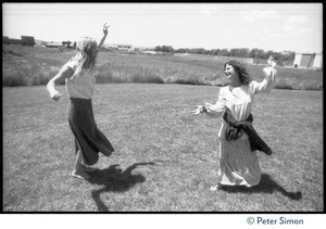 Cathy Brown (Usha, right) and unidentified woman dance on the lawn during Ram Dass's appearance at Sonoma State University