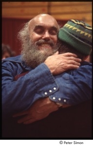 Ram Dass embracing a man after a lecture at Boston University