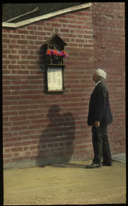 War Memorial, Canterbury (man looking at plaque on brick wall)