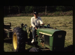 Dan Keller driving a tractor, Wendell Farm