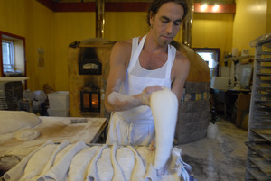 Hungry Ghost Bread: owner and baker Jonathan C. Stevens preparing bread dough for proofing