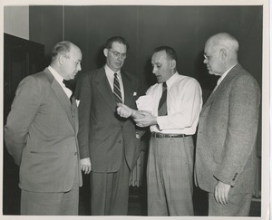 Four men at an insurance conference