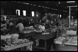 Woman selling produce at a market stall in the old marketplace, Belize City