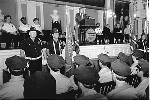 Mayor Raymond L. Flynn speaking to a group of Boston Police Officers and Boston Police Cadets from the podium at Fanueil Hall