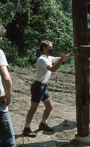 Peter McChesney pegging in a beam Moon Barn Raising at entrance to Hopkins Forest on 2 August 1975.