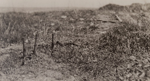 Three rifles sticking out of the ground along the top of a trench, Bayonet trench, Verdun