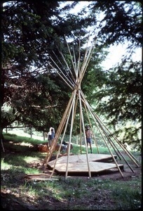 Mark Sommer and unidentified person setting up tipi poles