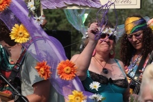 Purple Feather chocolate shop float in the parade, throwing beads to the crowd : Provincetown Carnival parade