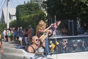 Grand Marshall Charo riding in the parade, waving to the crowd : Provincetown Carnival parade