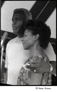 Party at Jackie Robinson's house: Rachel Robinson showing David Robinson  how to feed a baby with