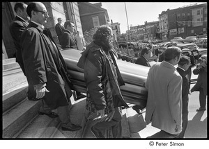 Jack Kerouac's funeral: pallbearers carrying casket down church steps, Allan Ginsberg center-front