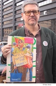 Occupy Wall Street: demonstrator holding photograph of a person holding a 'will work for money' sign