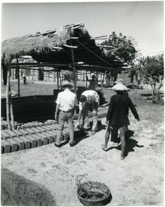 David Entin examining bricks baking in the sun