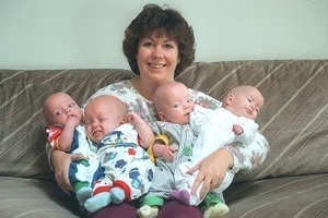 Ann Anderson holding her quadruplets