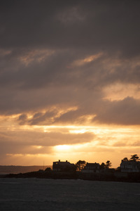 Houses on a point of land at sunset