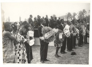 Officials of the Ghanaian government stand on a dais at the state funeral of W. E. B. Du Bois