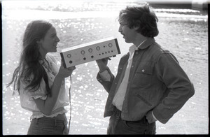 Lacey Mason and Elliot Blinder holding stereo equipment