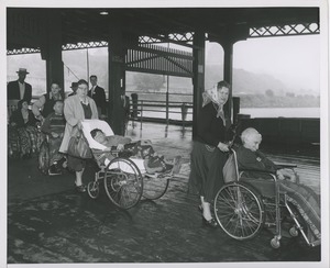 Women assisting wheelchair users outside