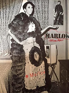A Photograph of Marlow Monique Dickson Posing in a Long Dress and Textured Coat