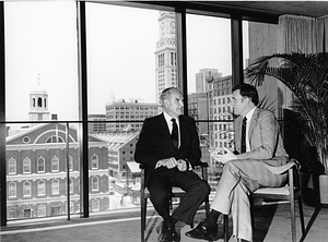 Mayor Raymond L. Flynn seated in his office with Governor Edward J. King